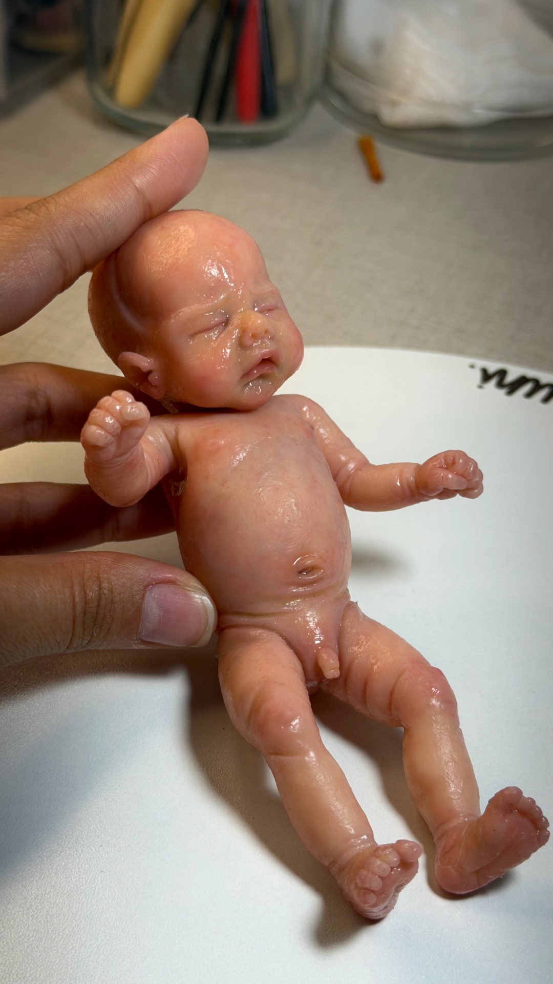 Close detail of a miniature silicone baby sculpture