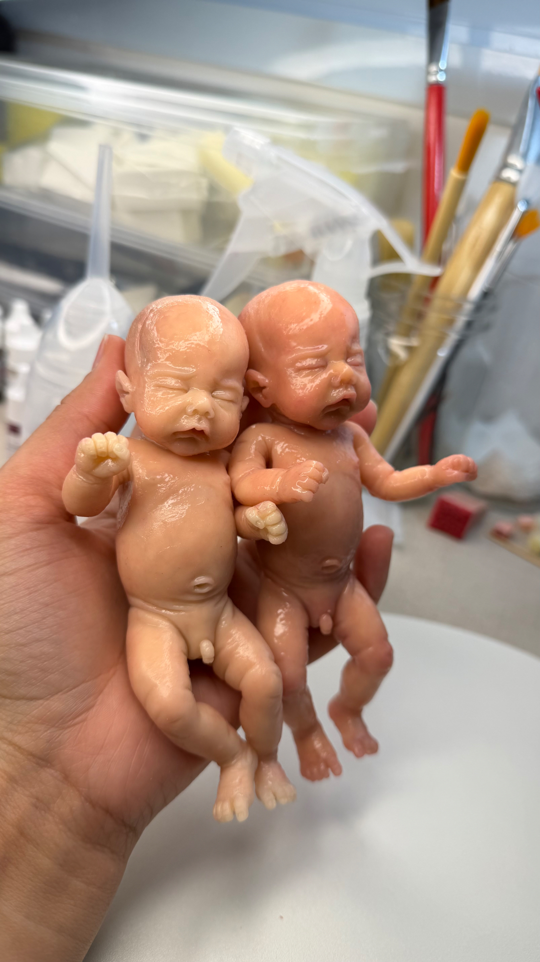A pair of miniature silicone babies in the studio